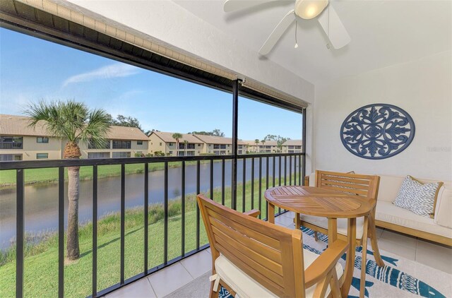 interior space featuring ceiling fan, a water view, and a residential view