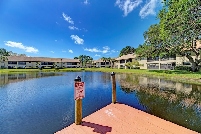 dock area featuring a water view and a residential view