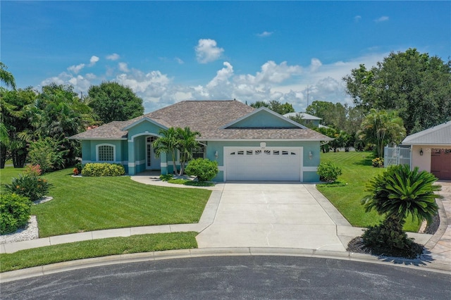 ranch-style home featuring driveway, stucco siding, and a front yard