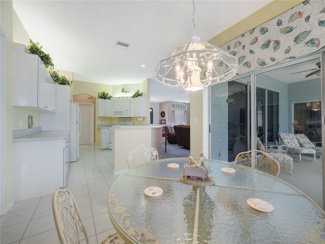 dining space with visible vents, a ceiling fan, and light tile patterned flooring