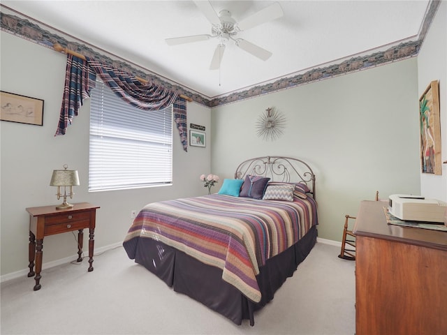 carpeted bedroom featuring ceiling fan and baseboards