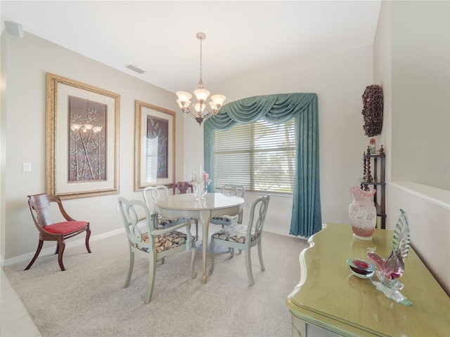 dining area featuring a chandelier, visible vents, and baseboards