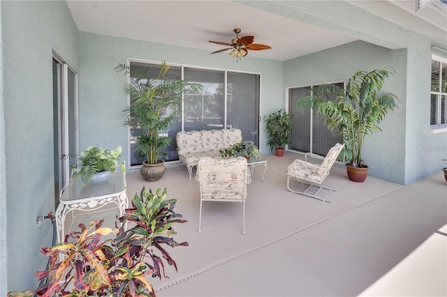 sunroom / solarium featuring ceiling fan