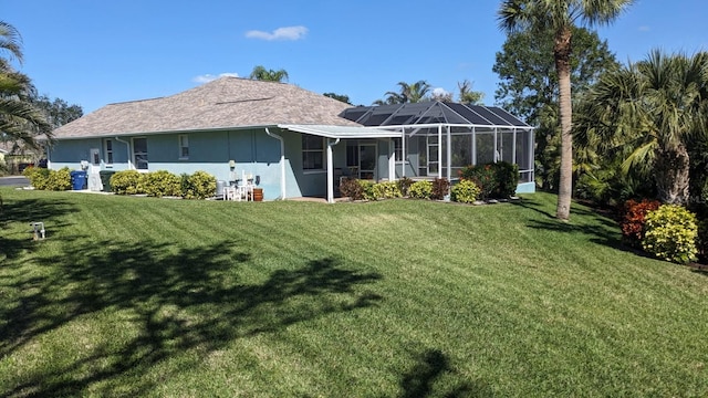 back of house with a lanai, a lawn, and stucco siding