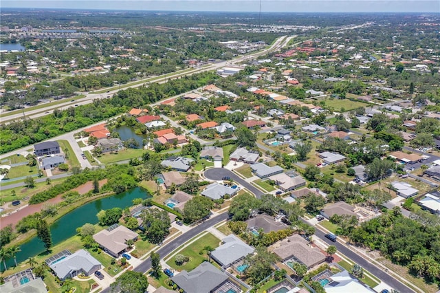 birds eye view of property featuring a water view and a residential view