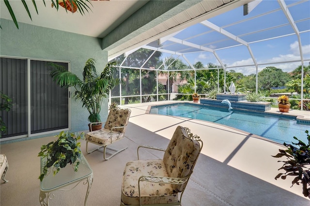 pool with glass enclosure and a patio area