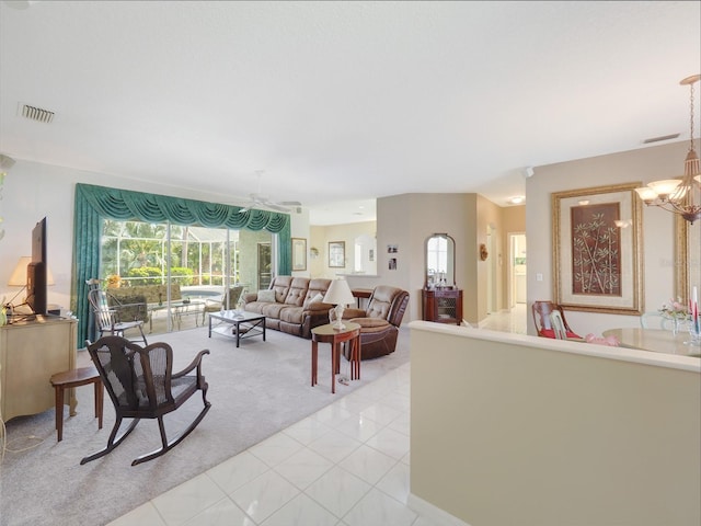 living area featuring a chandelier, a sunroom, light tile patterned flooring, and visible vents