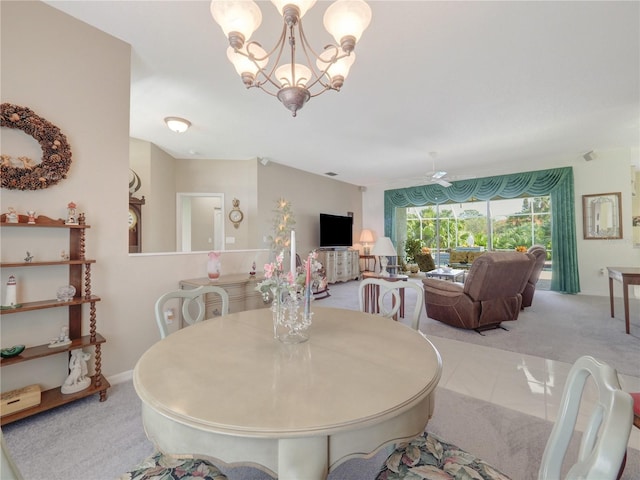 dining room featuring light carpet, light tile patterned floors, baseboards, and an inviting chandelier