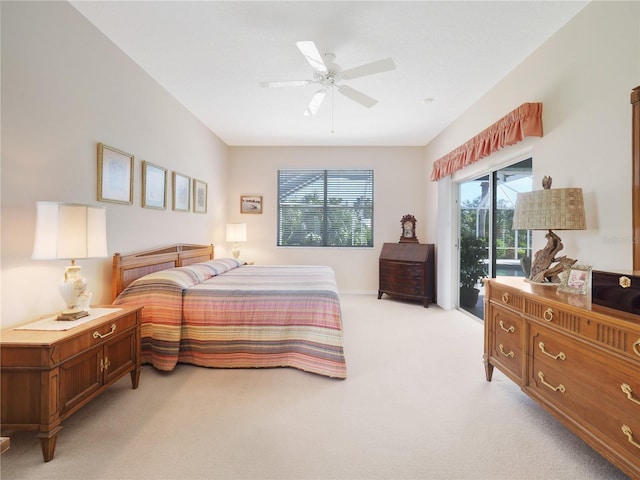 bedroom with access to exterior, light carpet, and ceiling fan