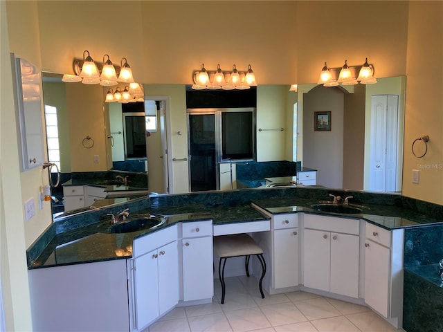 bathroom with a stall shower and a sink