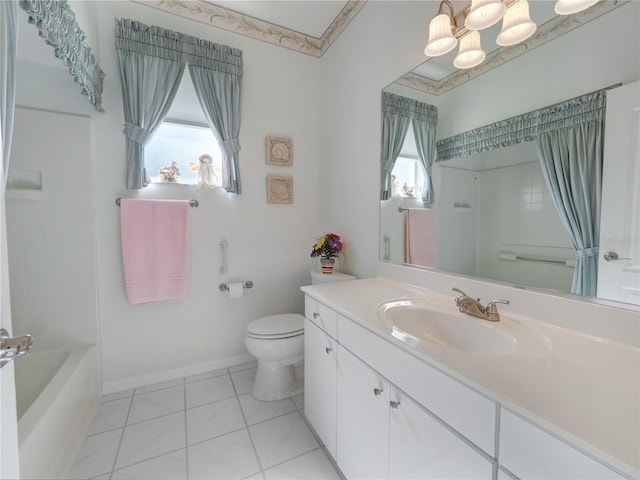 bathroom featuring baseboards, a healthy amount of sunlight, vanity, and toilet