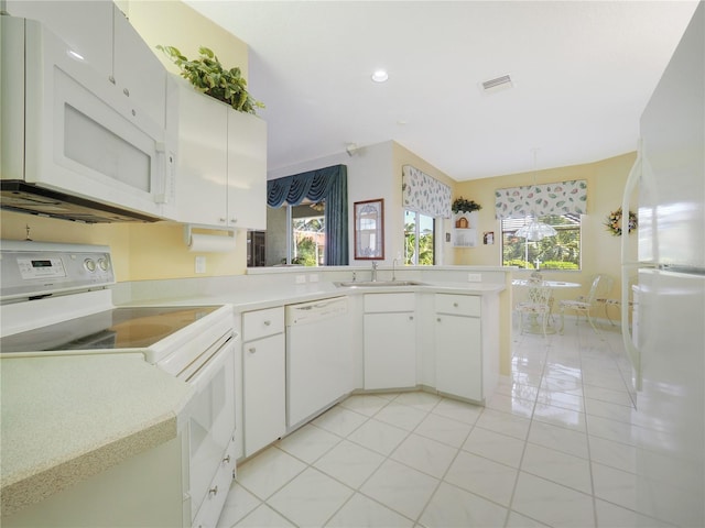 kitchen featuring white cabinets, white appliances, light countertops, and a sink