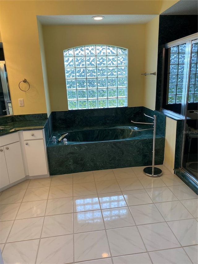full bathroom with vanity, a bath, a stall shower, and tile patterned flooring
