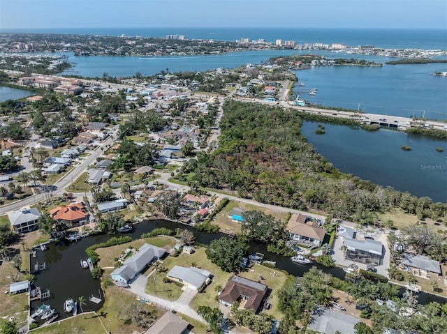 drone / aerial view featuring a water view and a residential view