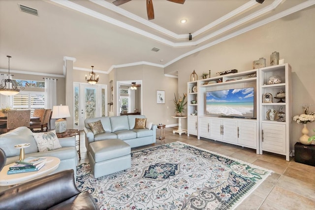 living room featuring light tile patterned floors, ceiling fan with notable chandelier, visible vents, baseboards, and ornamental molding