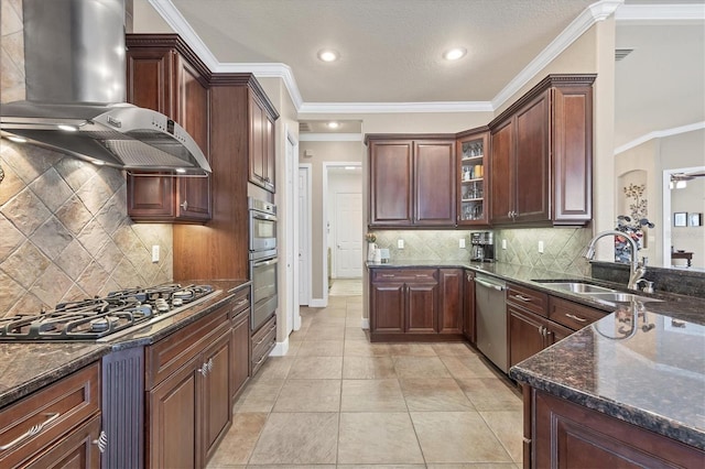 kitchen featuring range hood, glass insert cabinets, appliances with stainless steel finishes, a sink, and dark stone counters