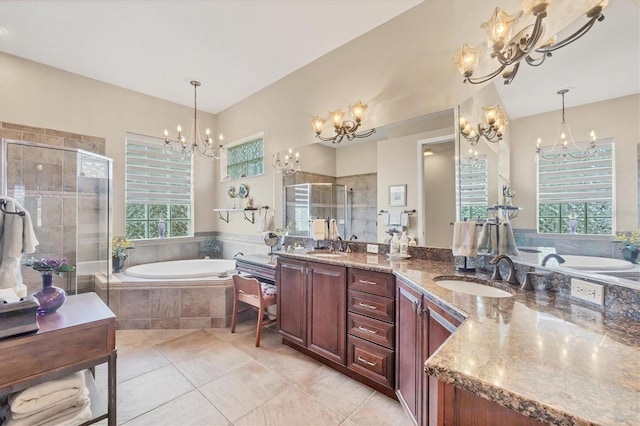 full bath featuring a bath, a stall shower, a chandelier, and a sink