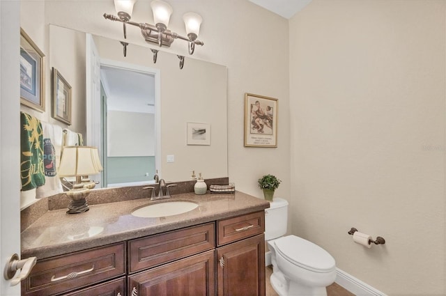 bathroom featuring toilet and vanity