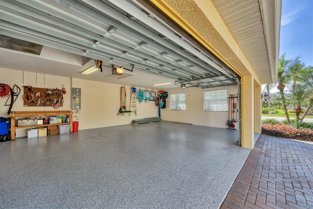 garage with electric panel and a garage door opener