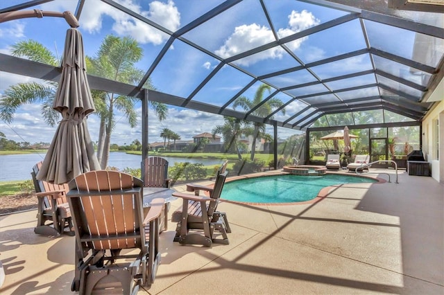 view of pool with a pool with connected hot tub, glass enclosure, a water view, and a patio