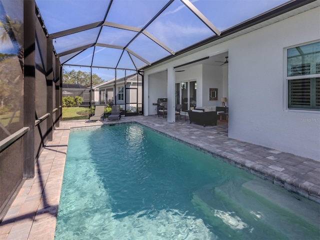 view of pool with ceiling fan, a lanai, an outdoor hangout area, a fenced in pool, and a patio area