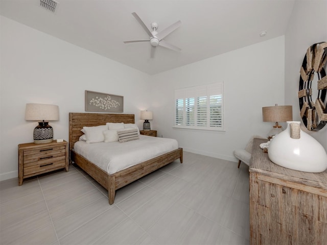 tiled bedroom with visible vents, ceiling fan, and baseboards