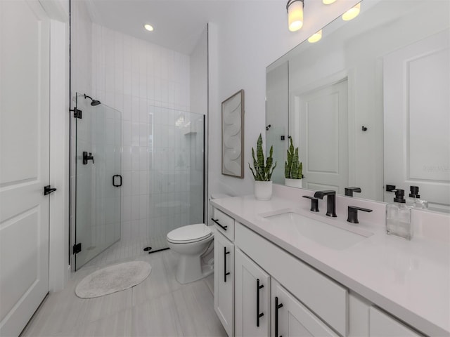 full bathroom featuring toilet, a shower stall, vanity, and recessed lighting