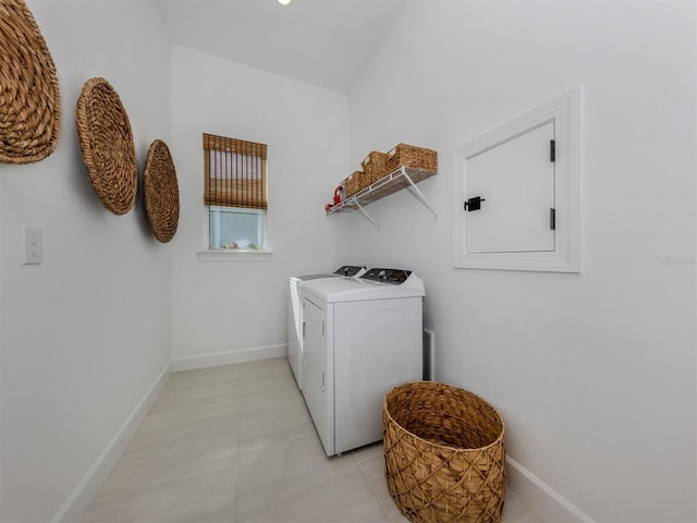 washroom featuring laundry area, washer and clothes dryer, and baseboards