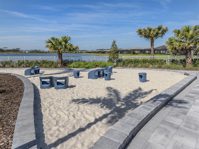 exterior space with a water view and fence