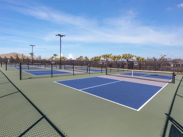 view of tennis court with fence