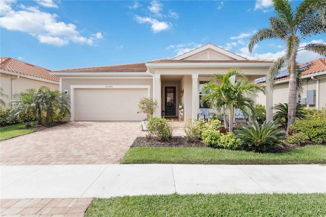 view of front facade with decorative driveway and an attached garage