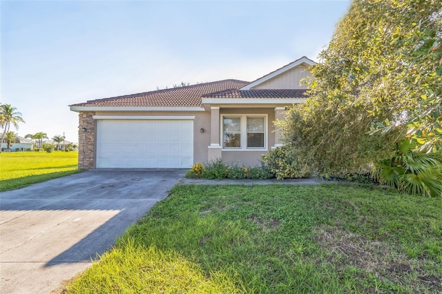 view of front of house with an attached garage, driveway, a tiled roof, stucco siding, and a front yard