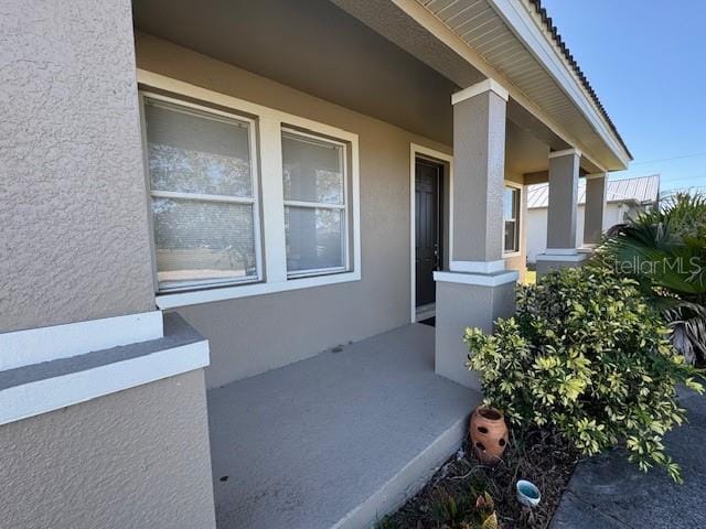 entrance to property featuring stucco siding