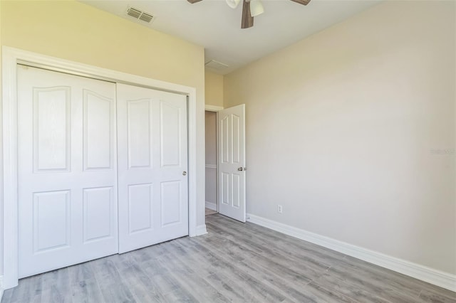 unfurnished bedroom with ceiling fan, visible vents, baseboards, a closet, and light wood finished floors