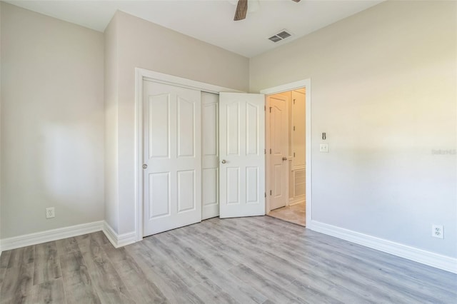 unfurnished bedroom with light wood-style flooring, visible vents, and baseboards