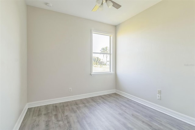 empty room featuring ceiling fan, light wood-type flooring, and baseboards