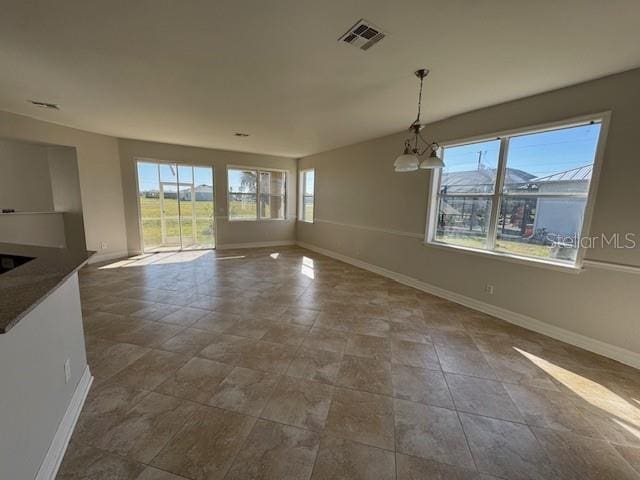 unfurnished dining area featuring visible vents and baseboards