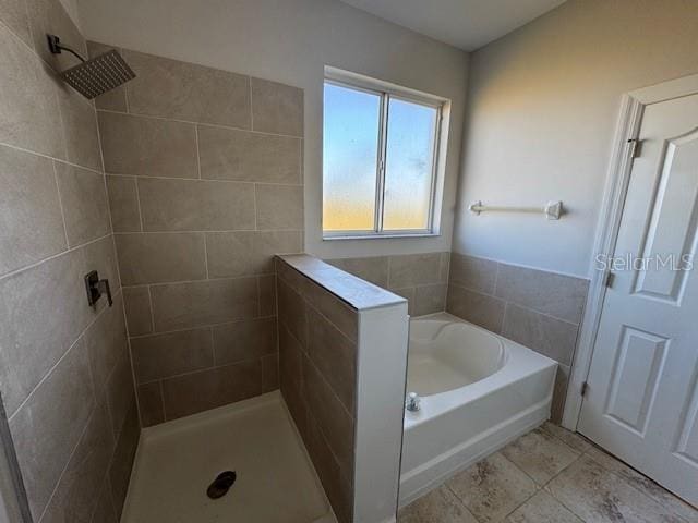 bathroom with tiled shower and a garden tub