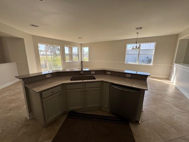 kitchen with a sink, visible vents, open floor plan, dishwasher, and decorative light fixtures