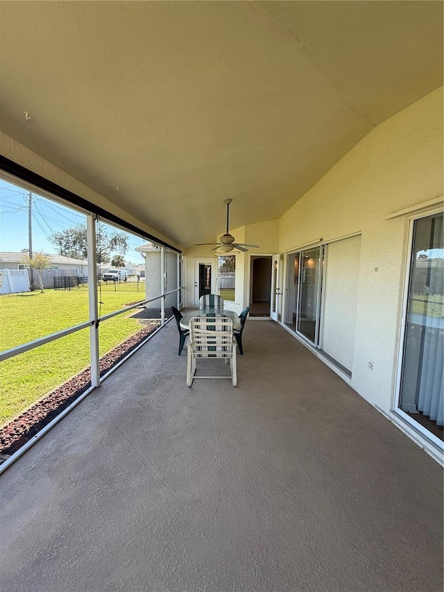 unfurnished sunroom featuring lofted ceiling and ceiling fan