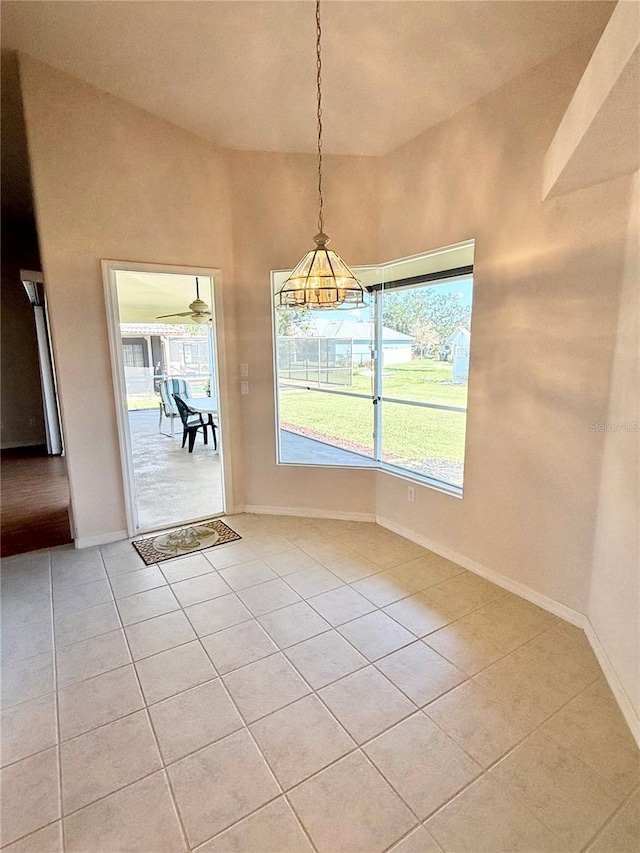 unfurnished dining area featuring light tile patterned floors and baseboards