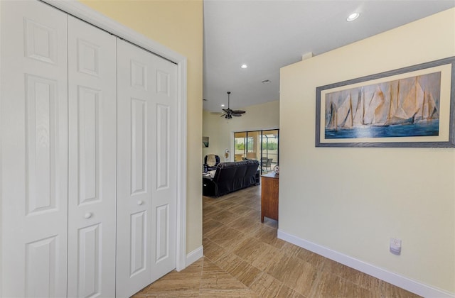 corridor featuring recessed lighting and baseboards