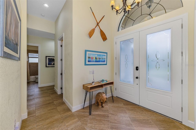 entrance foyer featuring baseboards and a notable chandelier