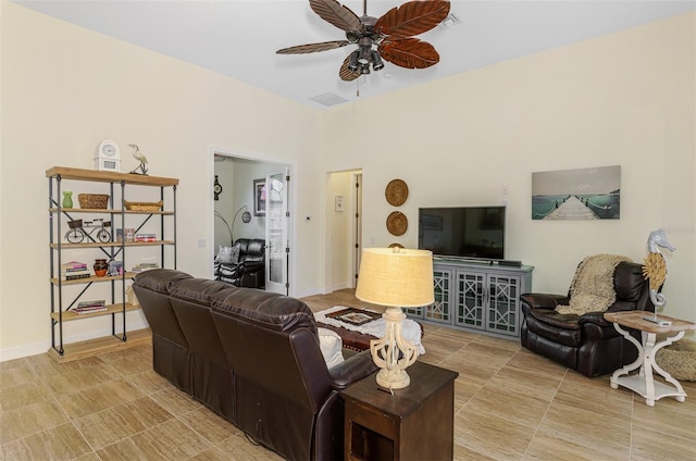 living room featuring ceiling fan, visible vents, and baseboards