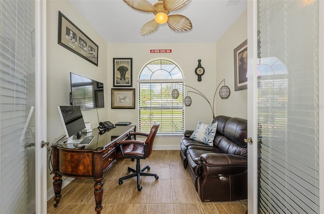 office with ceiling fan and baseboards