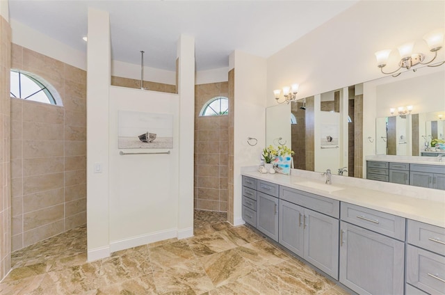 bathroom with walk in shower, a notable chandelier, and vanity