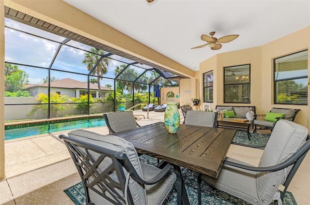 view of patio / terrace featuring ceiling fan, glass enclosure, an outdoor living space, and an outdoor pool