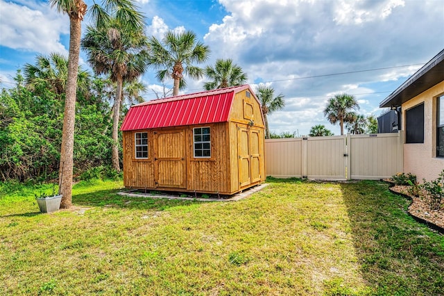 view of shed with fence and a gate