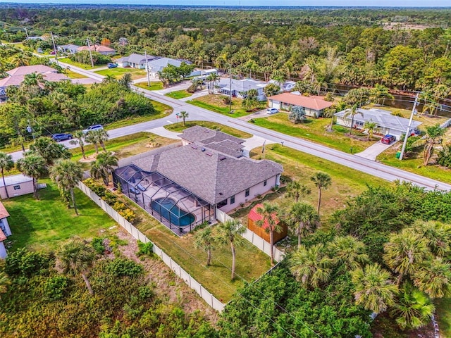 drone / aerial view featuring a forest view and a residential view