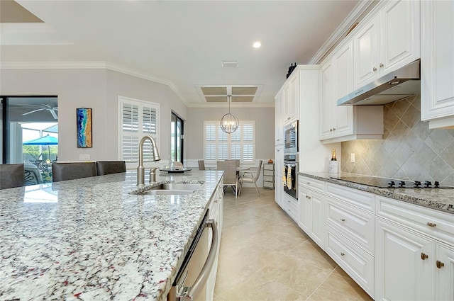 kitchen featuring stainless steel appliances, ornamental molding, white cabinets, a sink, and under cabinet range hood